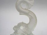 a glass candle holder that has a dragon on top of it