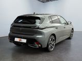 the rear end of a grey car in a showroom