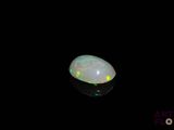 a white oplite in the dark with a black background