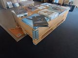 a lot of books sitting on a pallet on the floor