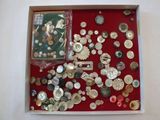 a lot of buttons in a box on the table