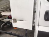 a white truck that has a door open and a bike in the back of it