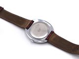 a close up of a wrist watch on a white surface