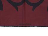 a close up of a red and black scarf with an owl on it