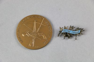 une médaille d'or et un ruban bleu sur un fond blanc