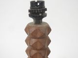 a wooden object with a black top on a white surface