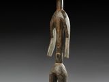 une image représentant une statue d'un homme debout sur un socle en bois