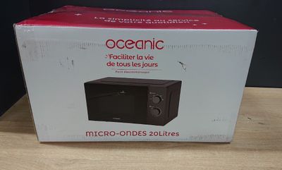 packaging of a microwave sitting on top of a wooden table