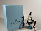 the figurine is sitting in a chair next to a blue box