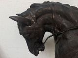 a statue of a horse with a bridle on it ' s head