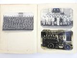 an old black and white photo of a group of men standing in front of a fire truck
