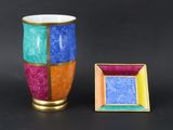 a vase and a picture frame sitting next to each other