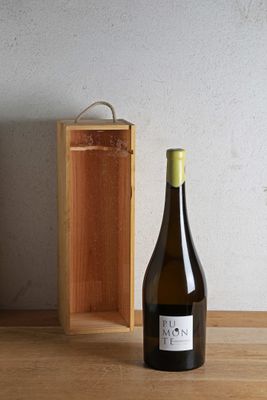 a bottle of wine sitting on a table next to a wooden box
