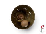 a small bowl with a wooden ball inside of it