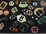 many different types of belts and buckles in a box
