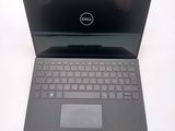 dell laptop computer with a pen and pencil sitting on a table