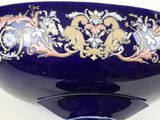 a blue bowl with a gold and blue design on it