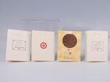three boxes of chocolate sitting next to each other on top of a table