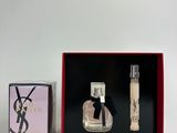 an image of a bottle of perfume next to a box of perfume