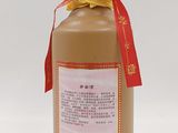 a bottle of brown liquid with a red ribbon around it