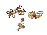 trois broches de couleur or ornées de fleurs et de feuilles