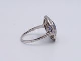 a close up of a ring with a blue stone in it