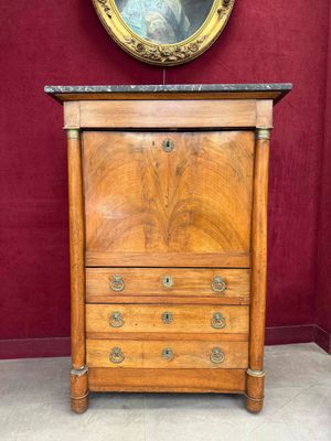 a wooden cabinet with a marble top and a mirror on the wall