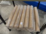 many rolls of plastic wrap on a cart in a warehouse