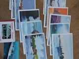 a lot of postcards on the table with pictures on them