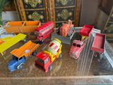 a lot of toy trucks that are sitting on a table