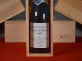 a bottle of wine in a wooden box on a table