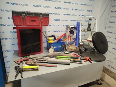 a table with tools on it in front of a wall