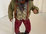 a figurine of a man with a hat and a cane
