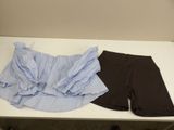 a pair of shorts sitting on a table next to a pair of shoes