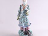 an oriental figurine of a man in a blue robe and hat
