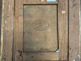 a painting of a wooden frame with a label on it