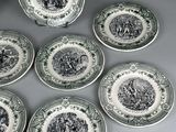 six green and white plates with black and white designs on them
