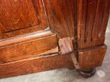 a close up of a wooden door with a rusted handle