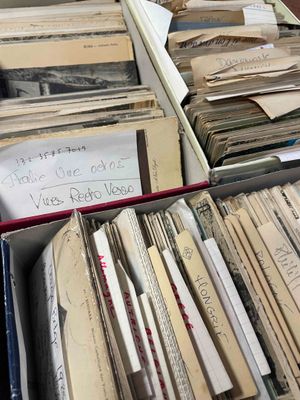 a lot of old papers in a box on a table