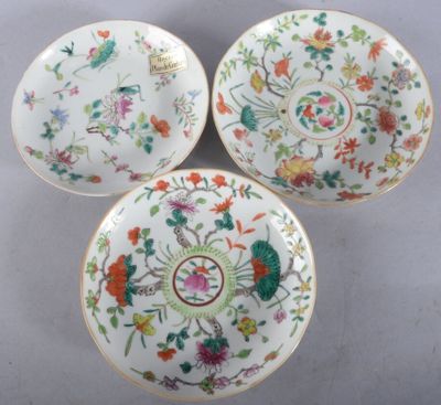 three chinese porcelain plates with floral designs on them on a table