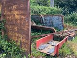 an old rusted bed and a broken bed in a field