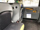 a seat in the back of a car with a yellow handle