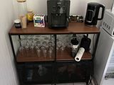 a coffee maker on a shelf in the corner of a kitchen