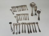 many forks and spoons laid out on the table