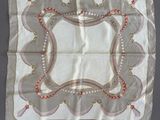 an old handkerchief with a design on it hanging on a wall