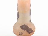 a small vase with a flower design on it