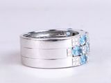 silver ring with blue stones and diamonds on a white background