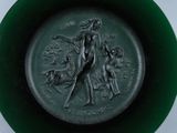 a green plate with a picture of a woman on it