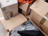 many boxes of clothing sitting on the floor next to each other
