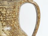 a brown vase that is sitting on a table